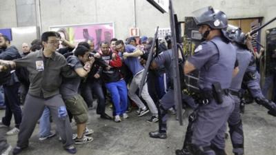 Subway train operators, along with some activists, clash with police at the Ana Rosa metro station on the second day of their metro strike in Sao Paulo