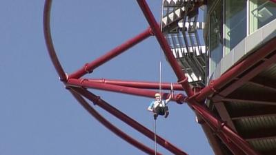 Sir Matthew Pinsent abseiling with Queen's Baton