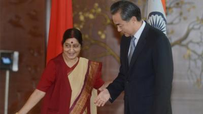 Chinese Foreign Affairs Minister Wang Yi is welcomed by Indian Minister for External Affairs Sushma Swaraj