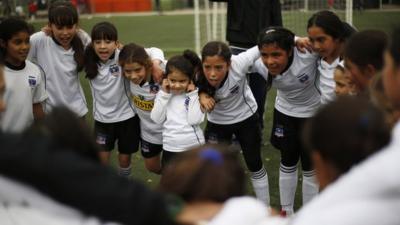 Group of girls in team huddle