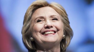 Former Secretary of State Hillary Clinton smiles before speaking at the World Bank in Washington