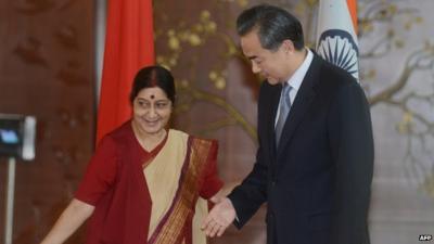 Chinese Foreign Affairs Minister Wang Yi is welcomed by Indian Minister for External Affairs Sushma Swaraj