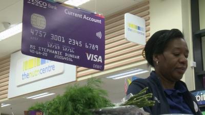 Tesco checkout with background sign