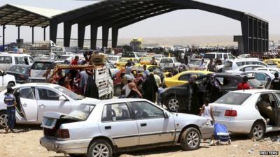 Families fleeing Mosul arrive at a checkpoint in outskirts of Arbil