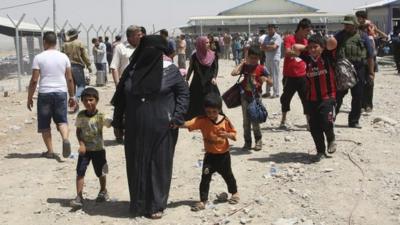 Families fleeing the violence in the Iraqi city of Mosul