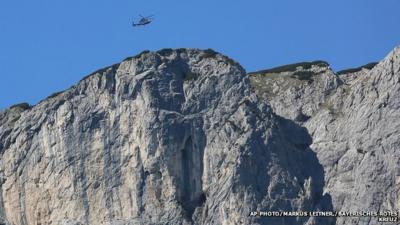 A helicopter flies above the Berchtesgaden Alps