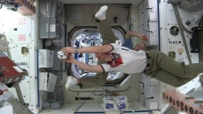 Astronauts playing with football in International Space Station