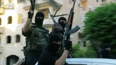 Picture from ISIS film of fighters in balaclavas holding guns