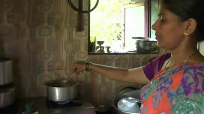 woman cooking on gas stove