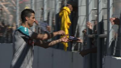 Ronaldo takes time to sign autographs for baying fans