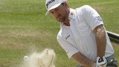 Graeme McDowell plays out of a bunker during his second round at the US Open