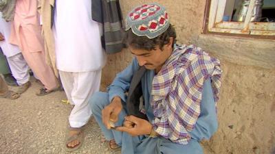 A man trying to remove ink on his finger