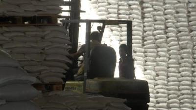 Sacks of food piled inside World Food Programme warehouse in Damascus