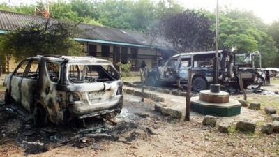 Charred vehicles sit outside a police station in Mpeketoni, in Lamu county along the Kenyan coast, after some 50 heavily-armed gunmen attacked the town near the coastal island and popular tourist resort of lamu the night before