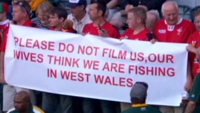 Wales rugby fans holding the banner at South Africa game