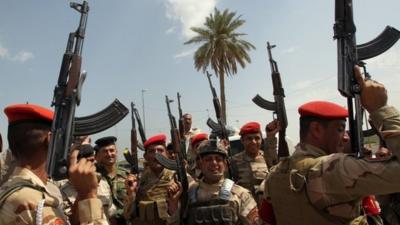 Iraqi army troops chant slogans against the Islamic State of Iraq and the Levant