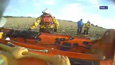 The man talks to the lifeboat crew