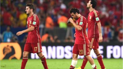 Spain players walk off dejected after being eliminated from the 2014 World Cup