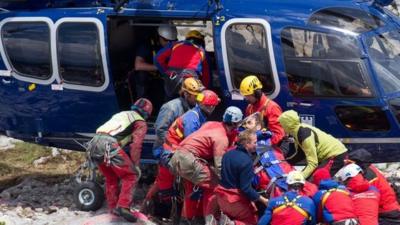 Johann Westhauser is carried to a helicopter by rescue workers