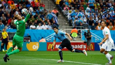 Uruguay's Luis Suarez scores against England