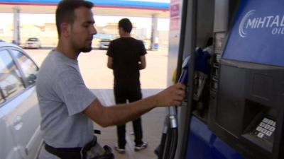 Man at petrol pump in Irbil, Iraq