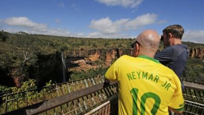 A British fan wearing a Neymar jersey looks at a waterfall in Chapada dos Guimaraes National Park near the World Cup host city of Cuiaba, June 19, 2