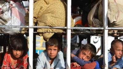 Pakistani children arrive by truck with some belongings in the neighborhood of Bannu, after fleeing North Waziristan tribal region in northwestern Pakistan