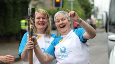 Two women hold the baton on Day 2 of the Queen's Baton Relay in Scotland