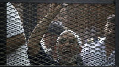 File photo: Egyptian Muslim Brotherhood leader Mohammed Badie gesturing as he shouts from inside the defendants cage during his trial in the capital Cairo, 7 June 2014