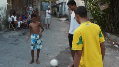 Locals playing football in Brazil's favelas