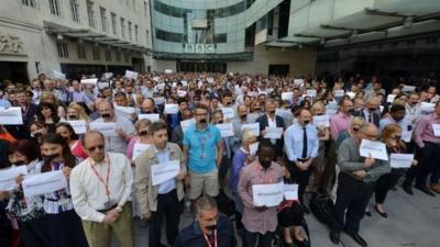 BBC journalists in London join colleagues from other news organisations for a silent protest outside New Broadcasting House