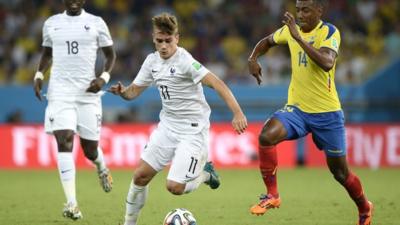 France's Antoine Griezmann and Ecuador's Oswaldo Minda vie for the ball in their World Cup group game