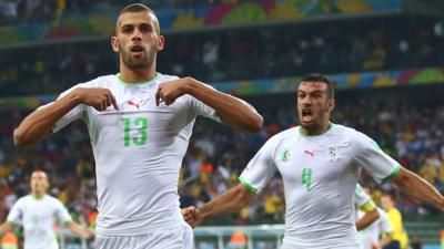 A controversial equaliser from Islam Slimani was enough to secure Algeria qualification for the last 16