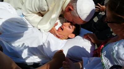 Pope Francis blessing a girl