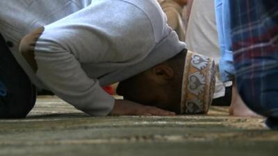 A man bows his head in prayer
