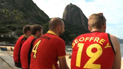 Belgium fans sit at the beach in Rio