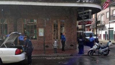 Authorities continue working the scene along Bourbon Street after a shooting, early Sunday, June 29, 2014, in New Orleans