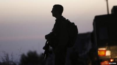 Israeli soldier stands guard in Hebron