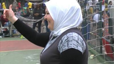 Syrian refugee woman as goal keeper