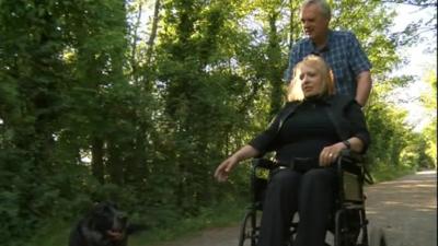 Joyce and Peter Baker take their dog for a walk