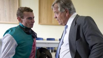 Trainer Sir Michael Stoute speaks to jockey Ryan Moore