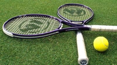 Tennis racquets and a tennis ball