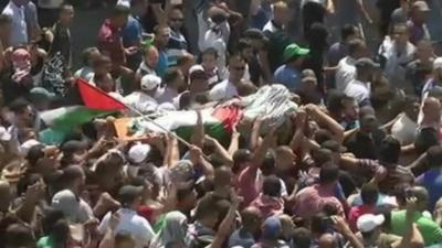 Mohammed Abu Khdair's body is carried through the streets