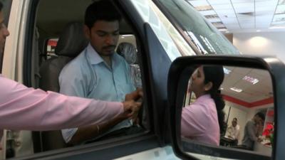 Customers in a car showroom