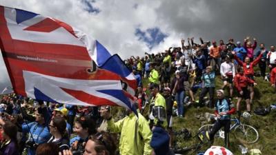 Supporters are pictured along the road during the 190.5 km first stage of the 101st edition of the Tour de France cycling race on July 5, 2014