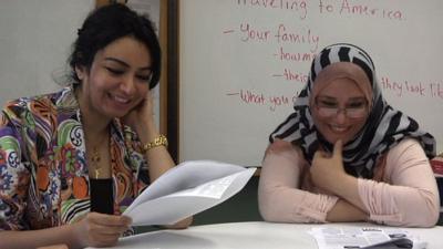 Two Iraqi refugees in a classroom in Virginia