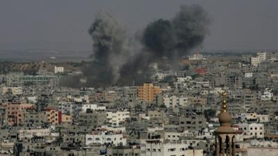 Smoke billows from buildings following an Israeli air strike on Gaza City