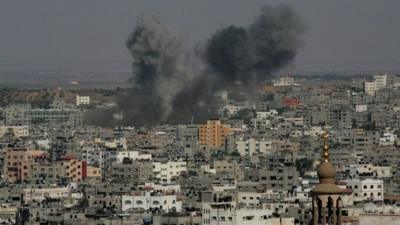 Smoke billows from buildings following an Israeli air strike on Gaza City