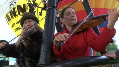 Violinists in a hot air balloon