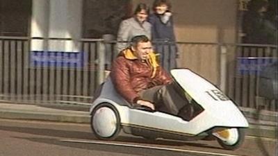 BBC Wales reporter Elfyn Thomas drives a Sinclair C5 in Cardiff city centre in 1985